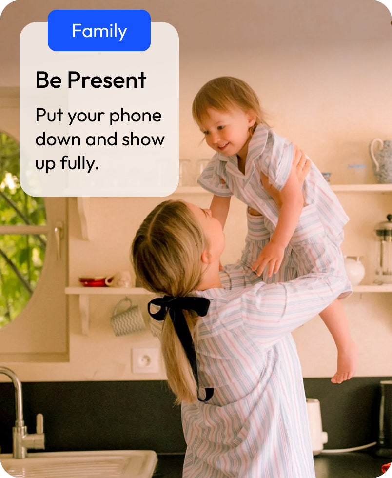 Text reads: 'Family: be present - put your phone down and show up fully.' Two children in a kitchen with a text overlay about being present and putting down phones.